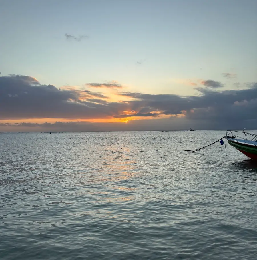 Atardecer en Jungutbatu Beach, en Nusa Lembongan, con el sol cayendo sobre el mar