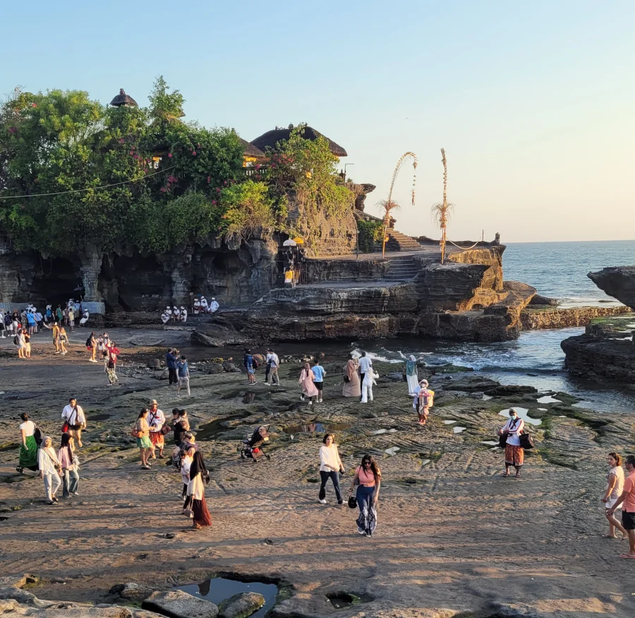 Templo Tanah Lot en Bali durante la marea baja con visitantes